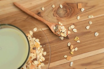 Oat flakes and milk on wooden background.
