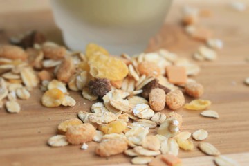 Oat flakes and milk on wooden background.