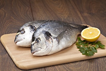 Dorada fish  with  lemon  prepared for cooking.