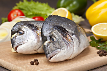 Dorada fish  with vegetables, lemon and spices prepared for cook