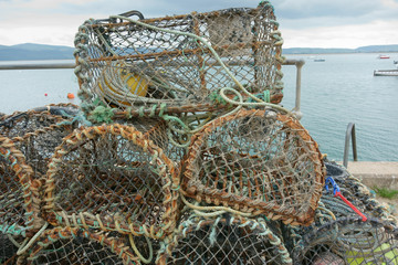 Crab pots on the quay in a small Welsh harbor, Wales, Uk