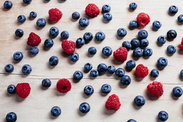 raspberry and blueberry juicy vitamin collection on wood table top view