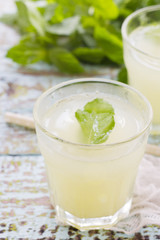 Obraz na płótnie Canvas Two glass of fresh lemonade decorated with mint leaves