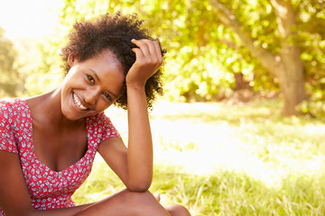 Young woman sitting on grass relaxing