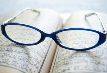 vintage eyeglasses on old blur Arabic book (Ramadan season)