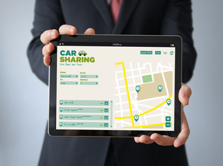 businessman with car sharing app on a tablet