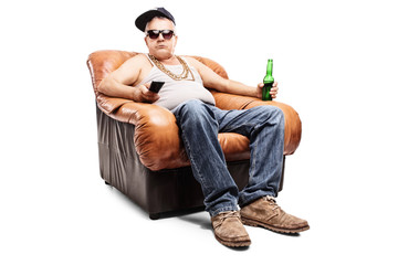 Senior in a hip-hop outfit sitting in an armchair
