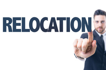 Business man pointing the text: Relocation