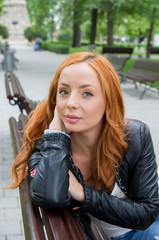 Beautiful blond woman sitting on bench