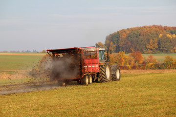 Naklejka premium Tractor at work. Tractor spread manure.