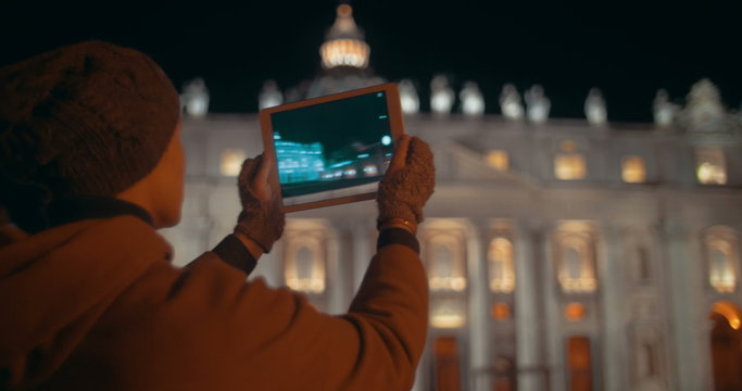 Making touch pad photos of night St. Peters Basilica