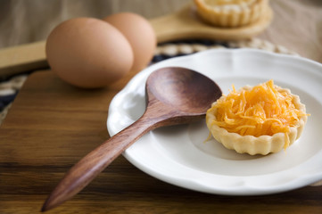 golden sweet tart on white plate