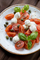 Close-up of caprese salad with capers, selective focus