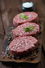 Raw cutlets made of minced beef meat, close-up, selective focus