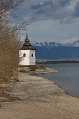 old church of Virgin Mary on coast of Liptovska Mara and Tatras, Liptov, Slovakia