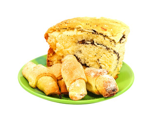Piece of poppy cake and fresh cookies isolated on white background.