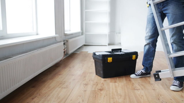 close up of man bringing tool box and ladder