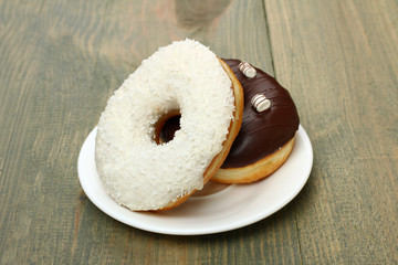 Donuts on a plate on wooden background