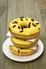 Donuts on a plate on wooden background