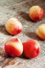 Ripe yellow-red nectarines on an old wooden table, selective foc
