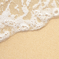 Sea wave over sand