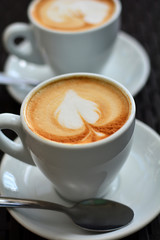 Delicious foamy cappuccino on the black background