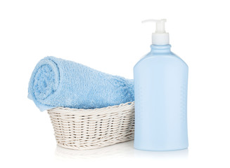 Obraz na płótnie Canvas Shampoo bottle and blue towel