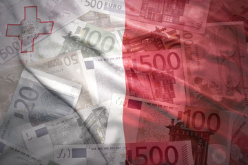 colorful waving maltese flag on a euro money background