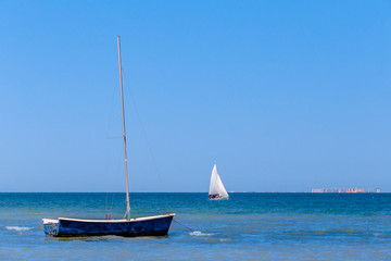 Calm blue sea with sailboats