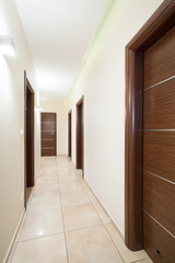 Wooden doors in beige corridor