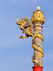 Fototapeta na wymiar Golden dragon statue on pole