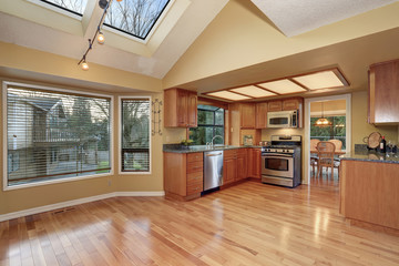 classic kitchen with hardwood floor and windows.