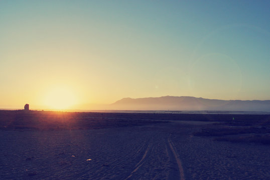 Summer landscape at sunset. Filtered image in faded, washed-out, retro style with lens flare; summer vintage concept.