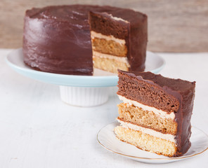 Chocolate, caramel and vanilla layered cake with chocolate ganache