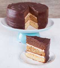Chocolate, caramel and vanilla layered cake with chocolate ganache