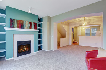 Classic living room with carpet and fireplace.