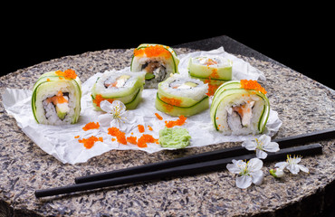 Traditional Japanese cuisine, sushi roll on a dark background.