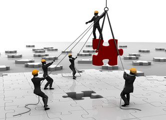 Jigsaw puzzle being built by teamwork. A great jigsaw puzzle being built by a succesful team.