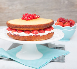 Victoria sponge cake with buttercream frosting, jam and strawberries