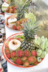 banana, rambutan, coconut, orange and pineapple in zinc salver