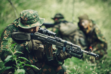 team of soldiers engaged in the exploration of the forest