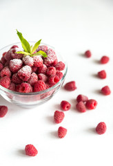 Fresh raspberries in the glass bowl