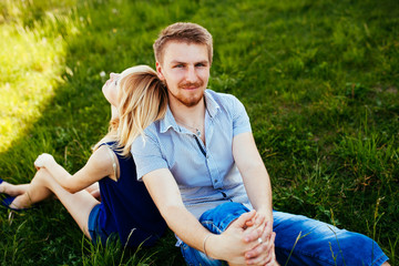 Happy Smiling Couple Relaxing on Green Grass.Park.