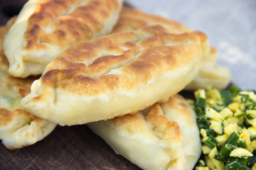 Fried pies on a wooden chopping board