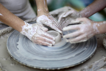 Two people working with clay