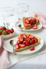 Tart with Greek yogurt and fresh strawberries on textiles