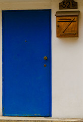 Obraz na płótnie Canvas Blue entrance door on cement colored building