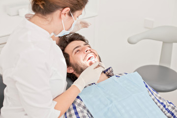 young happy man and woman in a dental examination at dentist