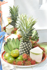 banana, rambutan, coconut, orange and pineapple in zinc salver