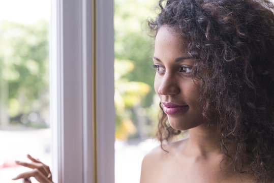 Portrait of pretty young woman looking at window